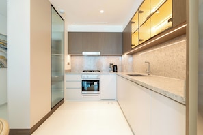 Deluxe Apartment, Balcony, Sea View | Private kitchen | Full-size fridge, microwave, oven, stovetop