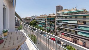 A multi-story residential building with balconies, a street view, and parked cars. - Michalakopoulou Corner & Bright Apartment, Luxury (Athens)
