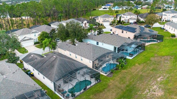 A residential area with houses featuring large glass-enclosed patios and swimming pools. - Davenport Luxury 8-Guest Villa (Davenport)