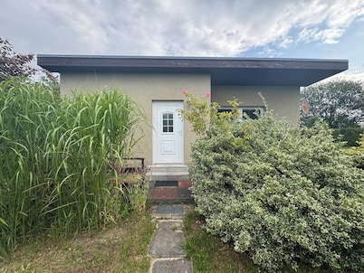 Idyllic bungalow surrounded by greenery, perfect for relaxing.