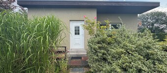 Idyllic bungalow surrounded by greenery, perfect for relaxing.