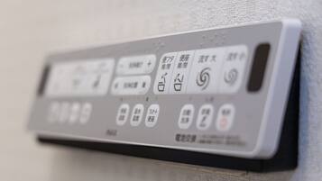 A close-up of a remote control with Japanese buttons.