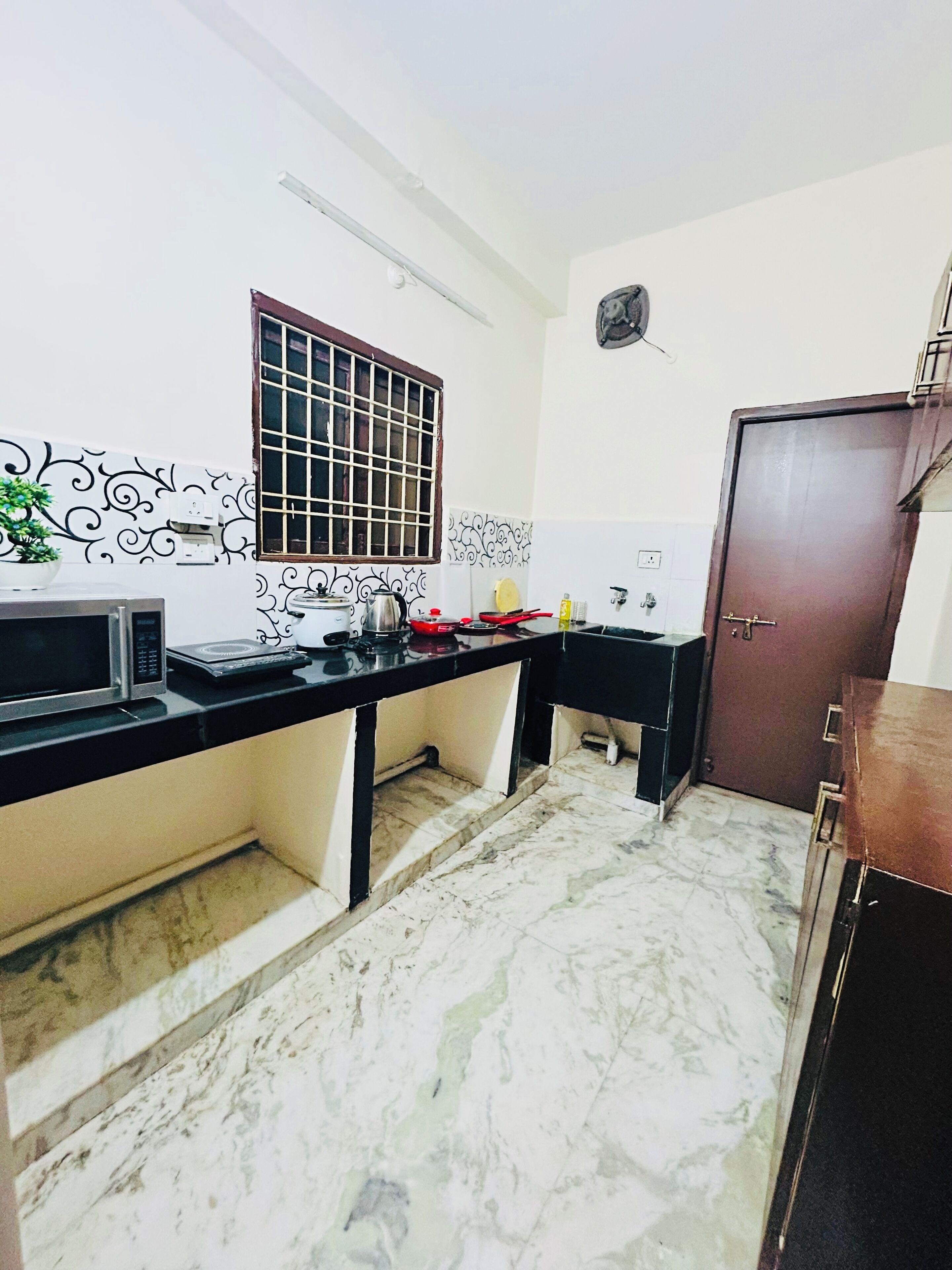 A kitchen with a microwave, stove, and sink.