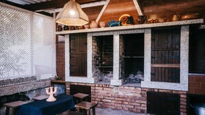 A rustic interior with exposed brick walls, wooden tables, and a hanging light fixture.