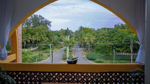 A view through a yellow arch window with a boat on a balcony railing. - 2BR Apt, 6-Min Walk to Diani Beach, Kids Playground, Near Ukunda Airport. (Diani Beach)