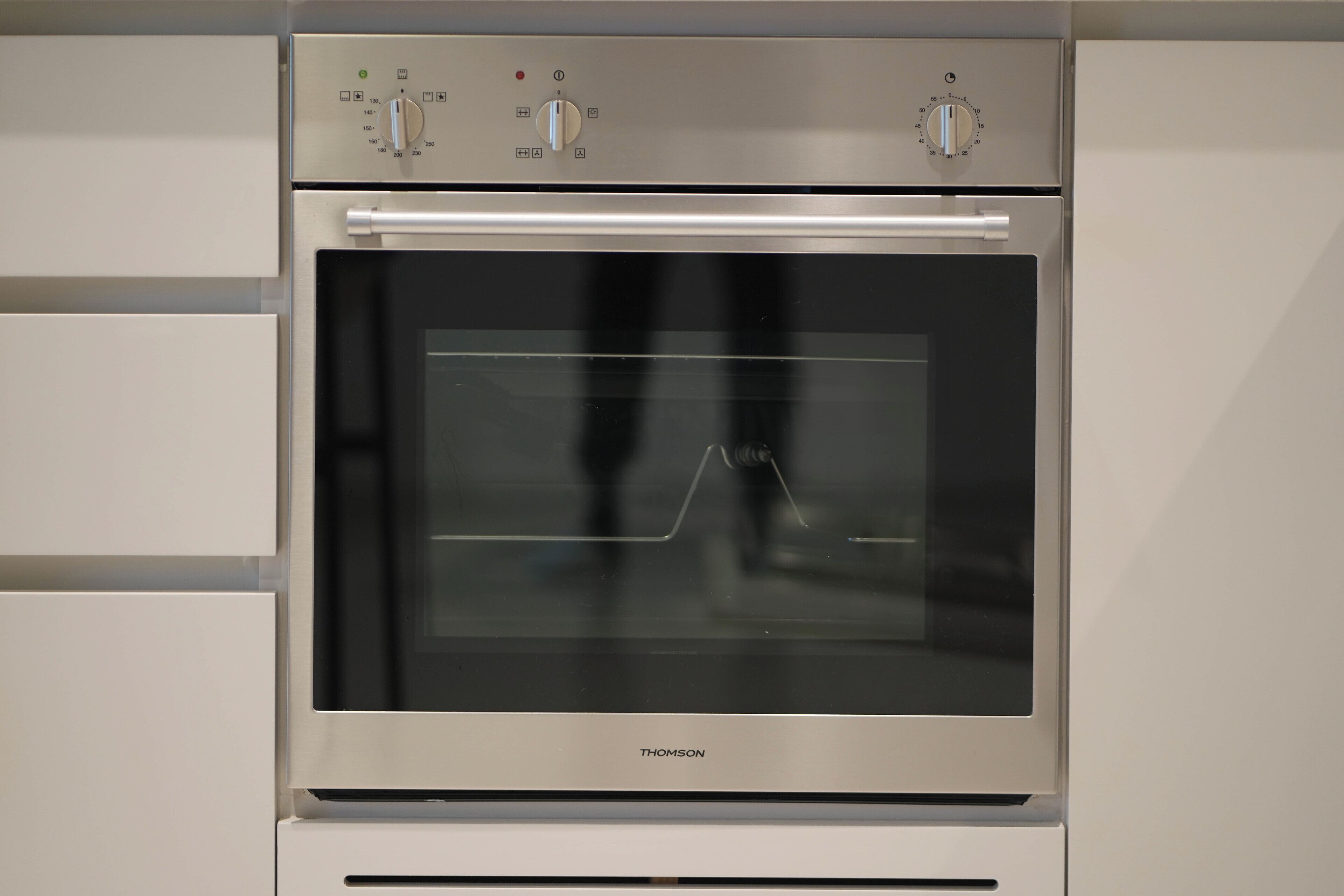 A stainless steel oven with a digital control panel and a glass door.