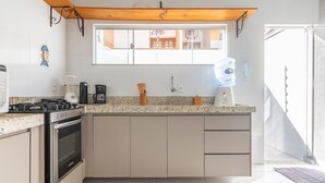 A modern kitchen with a built-in oven, a coffee maker, and a water dispenser. - Elegant Duplex w Sw. Pool 280m fr the Beach Prm007 (Santa Cruz Cabralia)