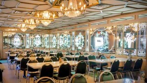 A banquet hall with multiple tables and chairs, ornate chandeliers, and large windows with decorative glass. - Beautiful Private Room, Near the AirPort - Free Parking (Miami)