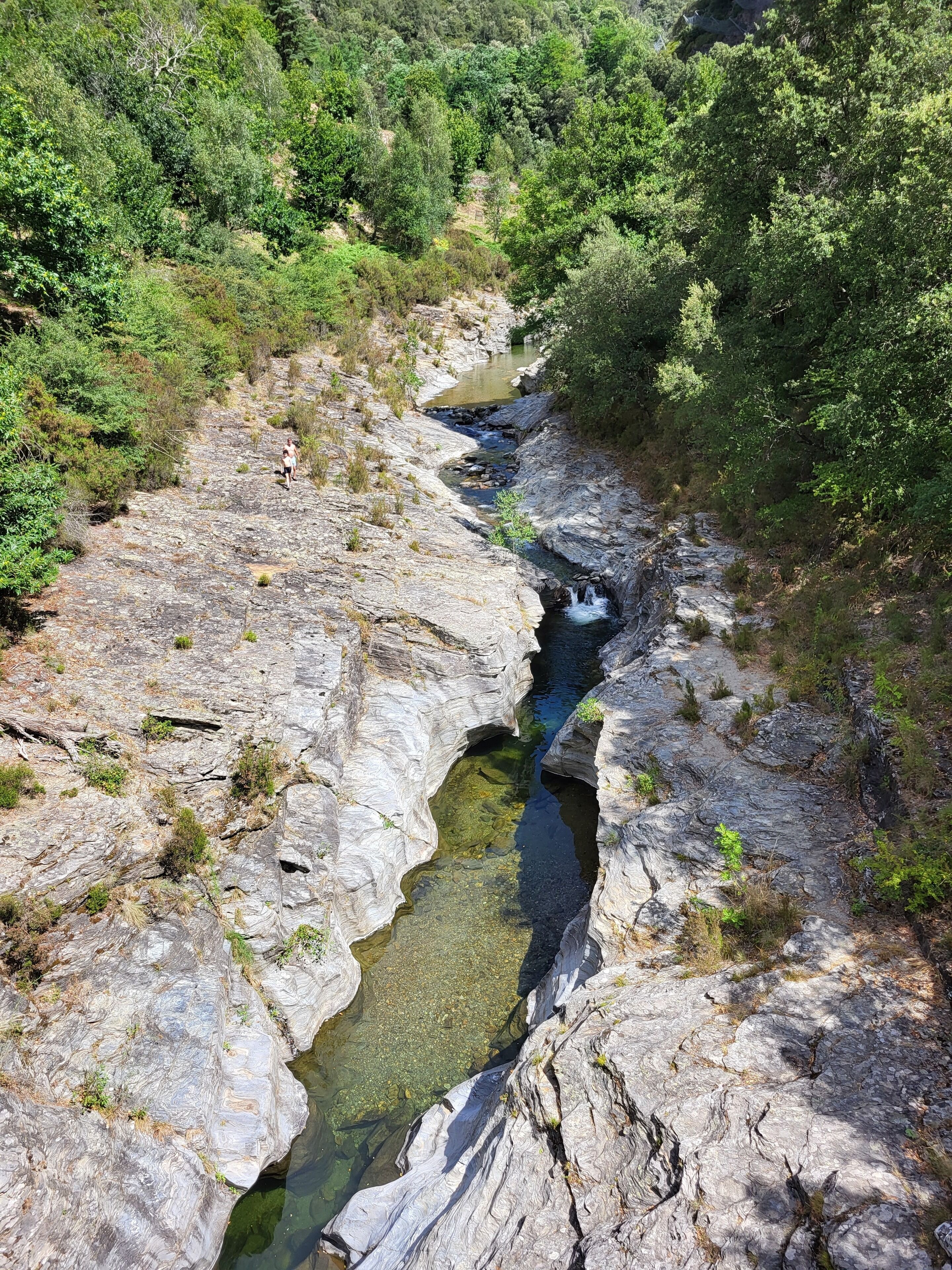 A rocky terrain with a narrow stream.