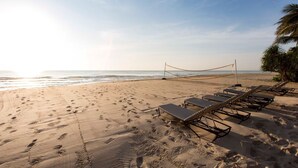 A beach with footprints, a volleyball net, and sun loungers. - Ace of Hua Hin Resort - One Bedroom Ace Seaview Suite Private Pool (Cha-am)