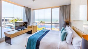 A modern hotel room with a large bed, a TV, and a view of the ocean. - Ace of Hua Hin Resort - One Bedroom Ace Seaview Suite Private Pool (Cha-am)