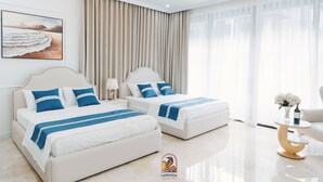 A modern hotel room with two beds, a large window with sheer curtains, a decorative vase with flowers on a side table, and a framed artwork on the wall. - Latritcia Boutique Hotel (Hai Phong)