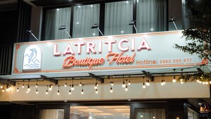 A hotel sign with the name 'Latritcia Boutique Hotel' and a dolphin logo. - Latritcia Boutique Hotel (Hai Phong)