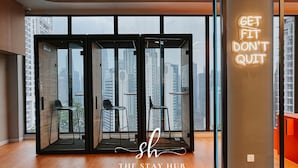 A modern hotel lobby with a large glass door leading to a balcony, a neon sign saying "GET FIT DON'T QUIT", and a logo for "THE STAY HUB Inspired by Home". - Majestic Residence KL by The Stay Hub  (Kuala Lumpur)