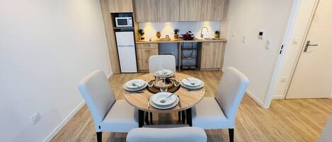 A modern kitchen with wooden cabinets, a built-in microwave, and a sink.