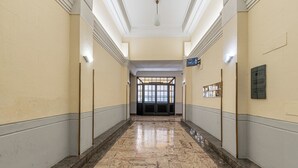 A marble-floored hallway with a sign reading "PORTFOLIO" and a door at the end. - Panurban Apartments by Wonderful Italy (Palermo)