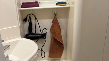 Een douche, een haardroger, handdoeken, toiletpapier