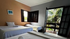A hotel room with two beds, a large window with a view of palm trees, and a ceiling light fixture. - Aruna Eco Pousada (Buzios)