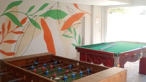 A room with a foosball table and a pool table, both in good condition. - Aruna Eco Pousada (Buzios)