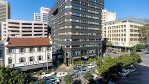 A multi-story building with a modern design, featuring a mix of commercial and residential spaces.