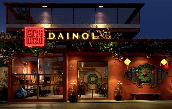 A building with a sign reading "DAINOL" and a number "63" on the facade.