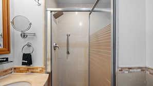 A modern bathroom with a glass-enclosed shower, a vanity with a sink, and a towel rack. - Oceanfront Oasis Couple s Retreat San Juan (San Juan)