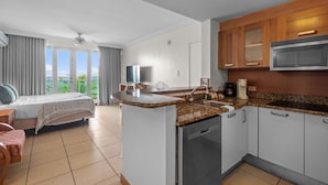 A compact hotel room with a kitchenette, a bed with a view, and a balcony. - Oceanfront Oasis Couple s Retreat San Juan (San Juan)