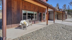 A modern building with a wooden exterior, large windows, and a covered patio area. - Modern Condo Near BH Attractions-garage Parking (Rapid City)