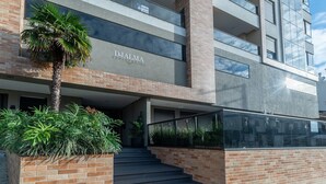 A modern building with a sign reading "DJALMA" and a staircase leading to the entrance. - DRL - Apartments 300m From Bombinhas Beach (Bombinhas)