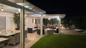 An outdoor patio area with seating and a pool. - Stunning 5 Star Home Retreat Private Pool Spa BBQ 4 BR (La Quinta)