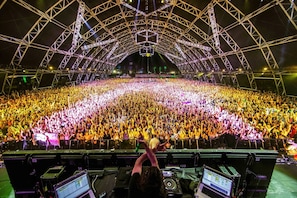 A large indoor venue with a high ceiling and a stage at the front.