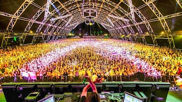 A large indoor venue with a high ceiling and a stage at the front.