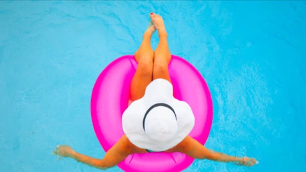 A person floating on a pink inflatable ring in a pool. - Fairway-view 3 Bedroom Condo in Palm Desert (Palm Desert)