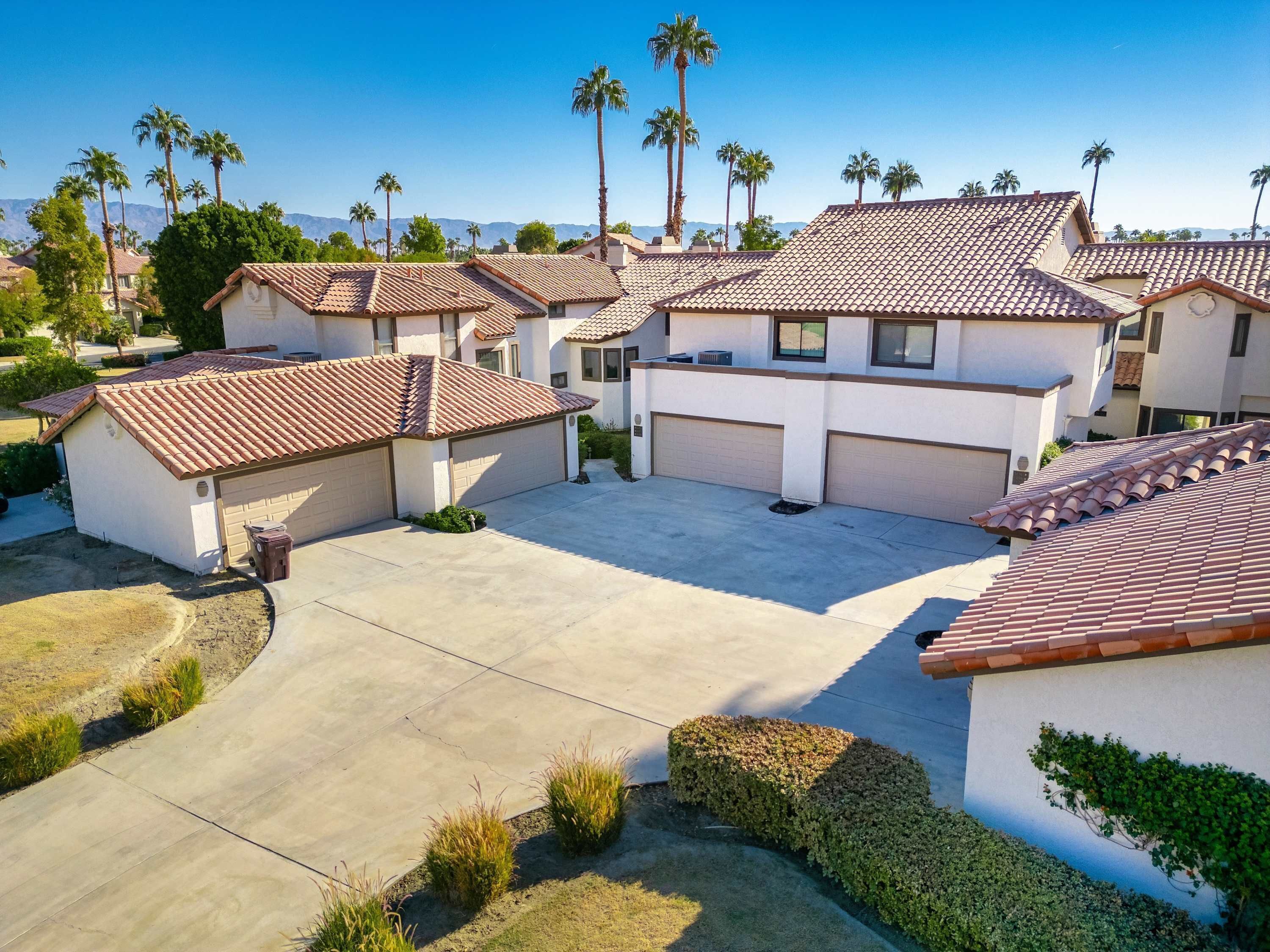 A residential area with multiple houses, each featuring a garage and a driveway.