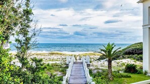 A wooden pathway leading to a beach with a view of the ocean. - Gulf Shores Hideaway Walk to Waves Pool Golf Views (Gulf Shores)