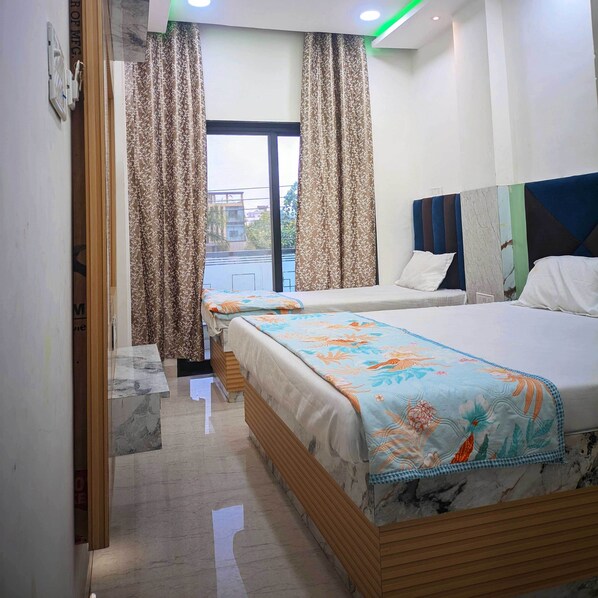 Deluxe Triple Room, City View | Desk, laptop workspace, free WiFi