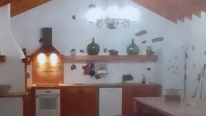 Una cucina rustica con travi in legno, un fornello e un lavello.