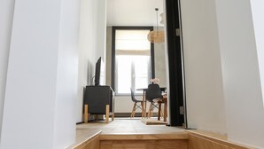 A staircase leading to a dining area with a table and chairs.