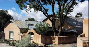 A historic mill house compound with a rustic, unfinished exterior and a metal roof. - Historic Millhouse Unit 1 (Taos)