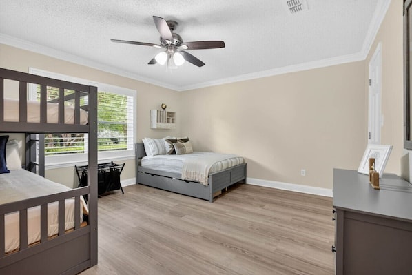 A bedroom with a bunk bed, a single bed, a ceiling fan, and a window with blinds. - 3BR Retreat w/ Firepit + Big Garden | Washer/Dryer (Tallahassee)