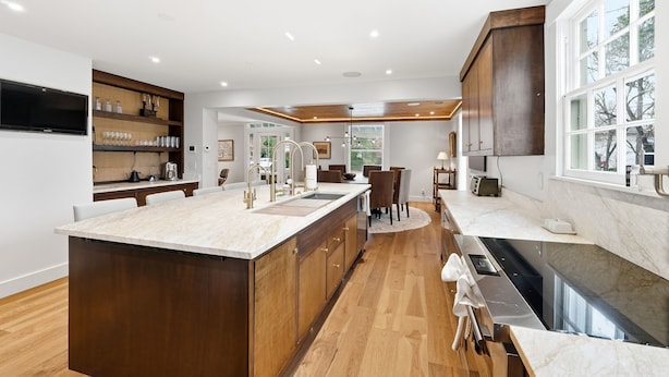 A modern kitchen with a large island, wooden cabinets, and a built-in oven. - Herty House: Walk to UGA & 5 Points (Upper Level) (Athens)