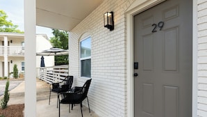 A white brick house with a grey door marked with the number 29. - Newly Decorated BEAUTY in Downtown Ocean Springs with optional GOLF CART. (Ocean Springs)