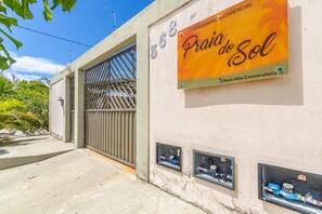 A building with a sign reading "Praia do Sol" and numbered utility boxes. - Apartment With Pool and Barbecue Pdl005 (Porto Seguro)