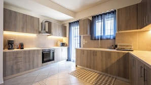 A modern kitchen with wooden cabinets, a microwave, and a coffee maker.