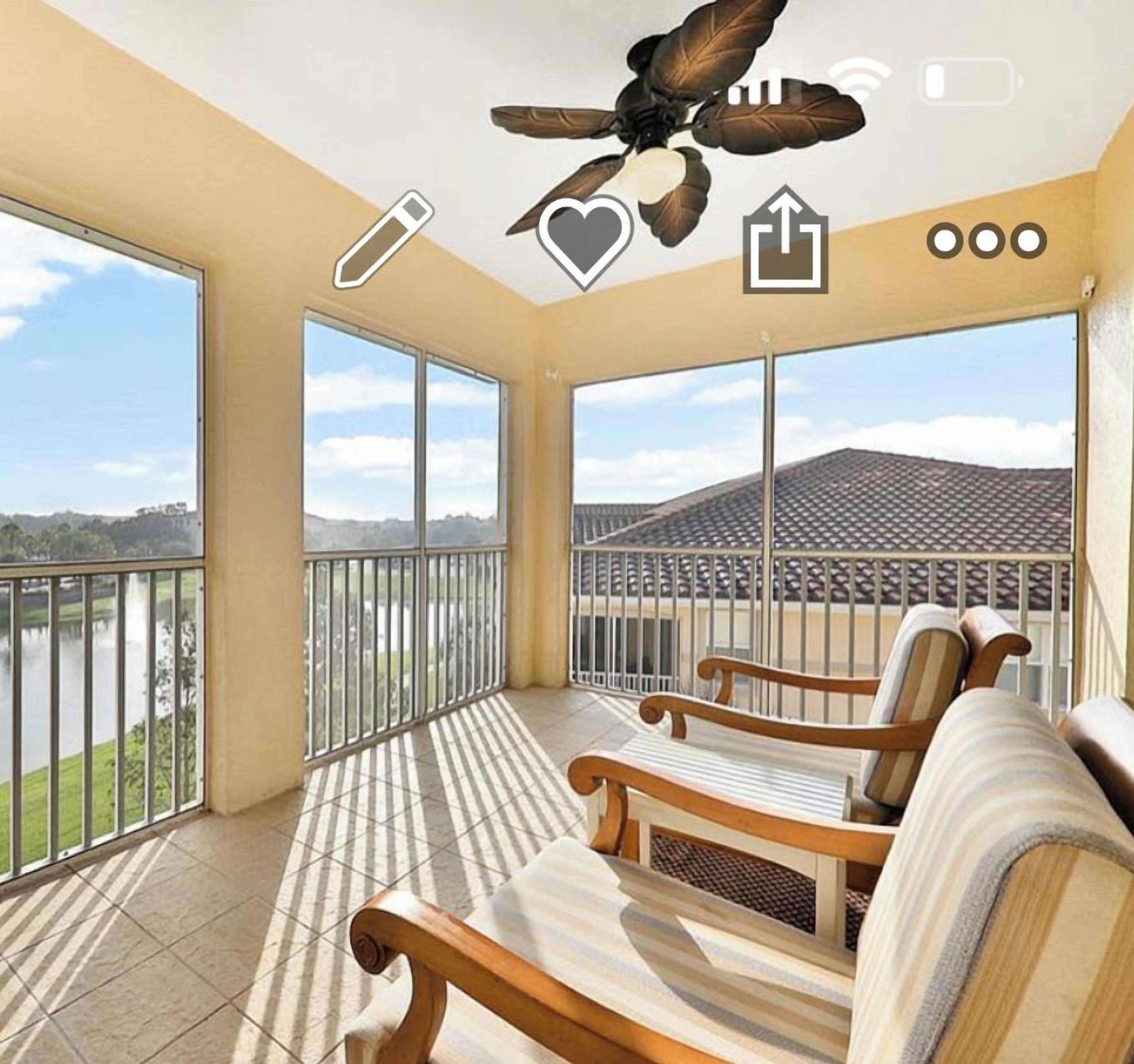 A balcony with a view of a body of water and a building across the street.