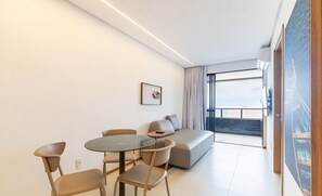 A modern living room with a round table, two chairs, a sofa, and a large window with a view. - Apt With Balcony and Sea View, Maceio Hig1003 (Maceió)