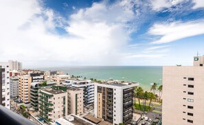 A high-rise building with multiple balconies overlooking a coastal area with a clear sky. - Apt With Balcony and Sea View, Maceio Hig1003 (Maceió)