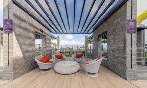 A rooftop patio with wicker furniture and a glass ceiling. - Studio w/ Pool 300m From the Beach- Maceio Eti0724 (Maceió)
