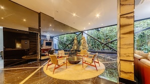 A modern interior with a circular seating area, a large window, and a staircase. - Studio w/ Pool 300m From the Beach- Maceio Eti0724 (Maceió)