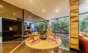 A modern interior with a circular seating area, a large window, and a staircase. - Studio w/ Pool 300m From the Beach- Maceio Eti0724 (Maceió)
